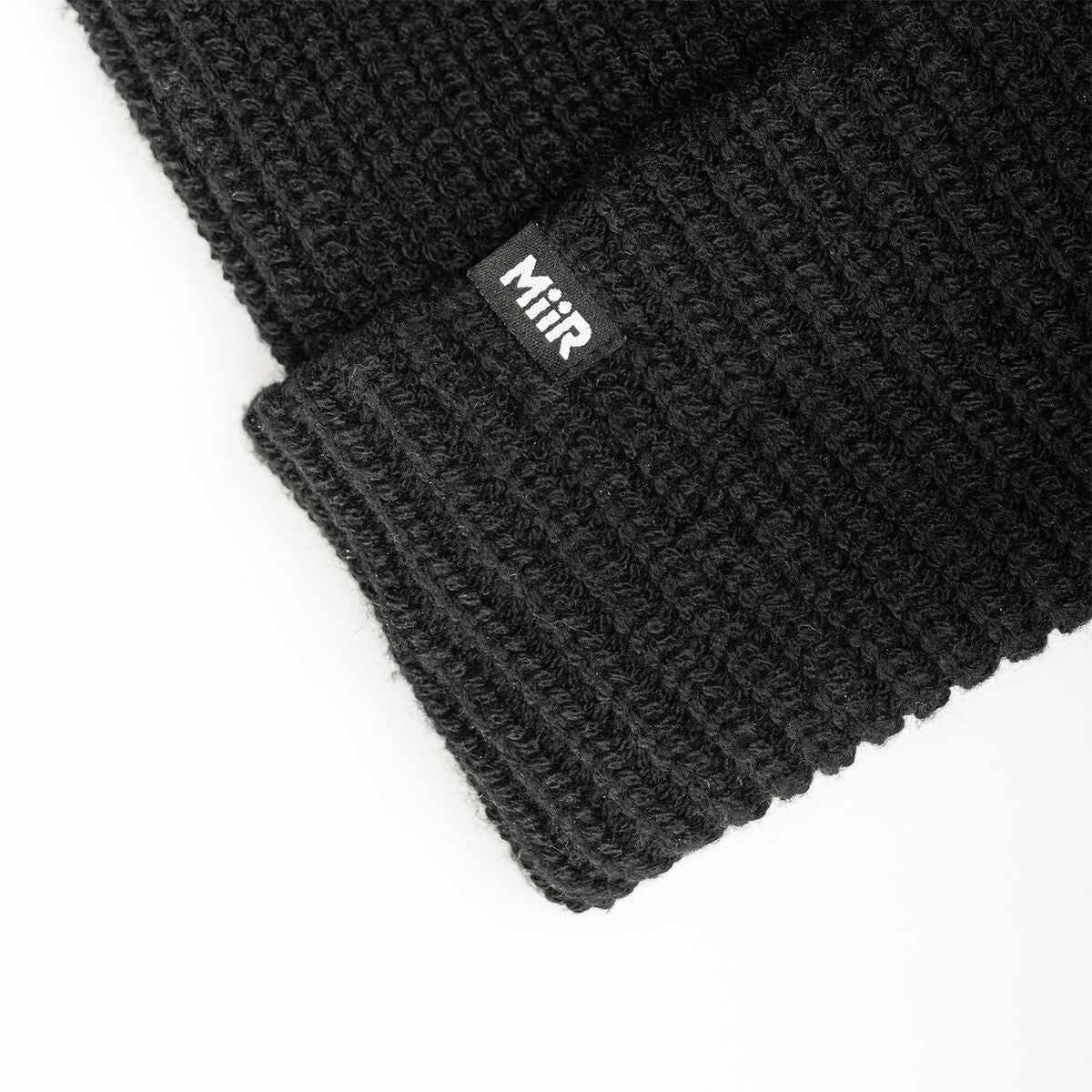 recycled-poly-rib-beanie-m4 WebPDP-RecycledPolyRibBeanie_Studio_TagDetail_Black__BNE002002OS.jpg